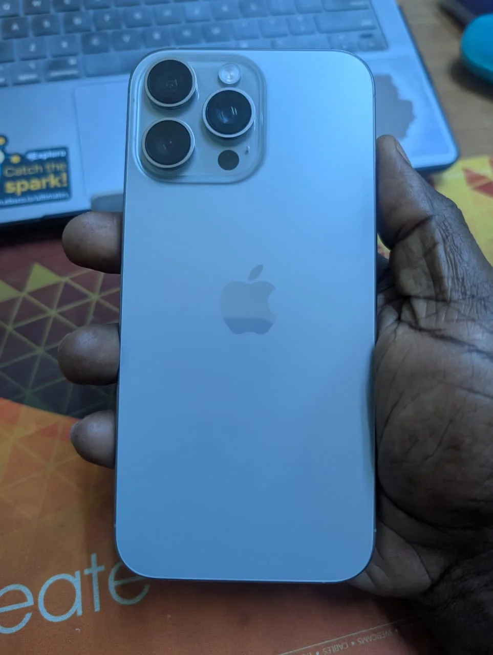 Back of Space Gray iPhone 16 Pro Max 256GB showing camera area and Apple logo