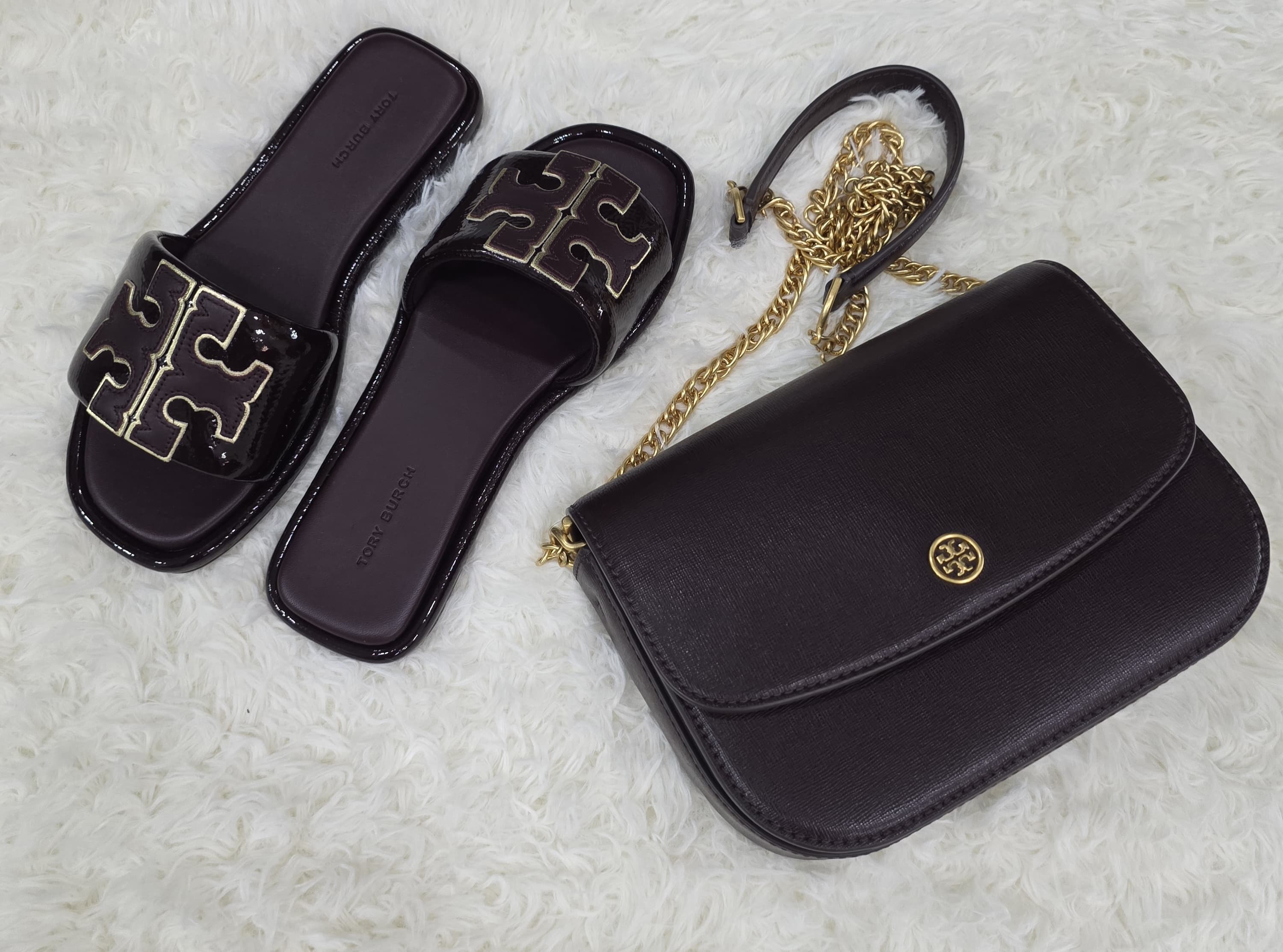 Dark branded bag and slides photo at The Source Arena JA.